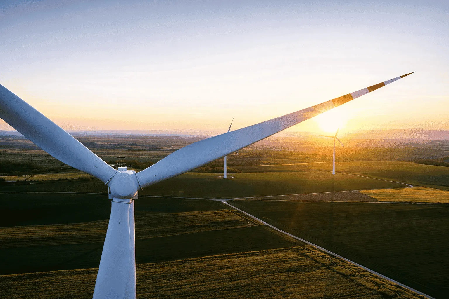 Wind turbine with a sunset in the background